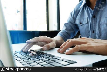 man using laptop computer at modern office