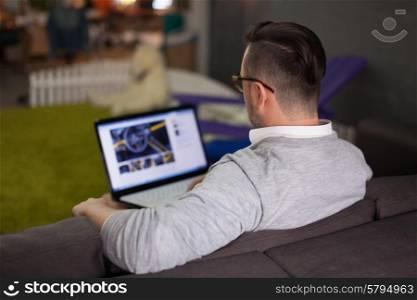 Man using laptop in startup office. Focus on man