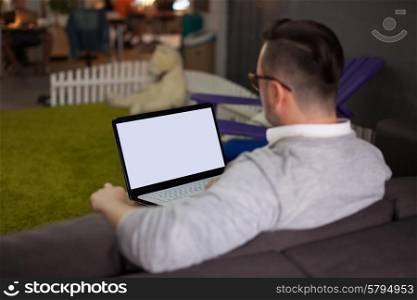 Man using laptop in startup office. Focus on screen