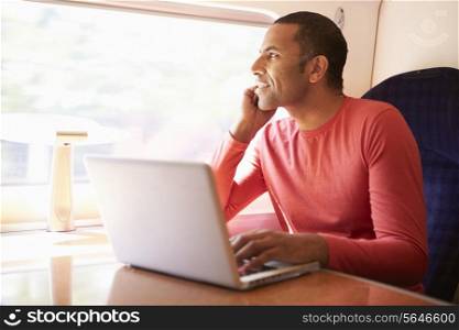 Man Using Laptop On Train