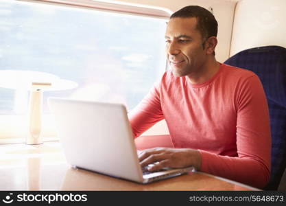 Man Using Laptop On Train