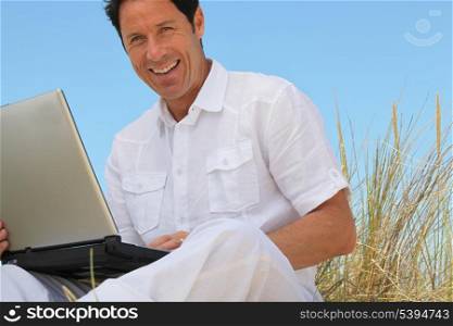 Man using laptop outdoors