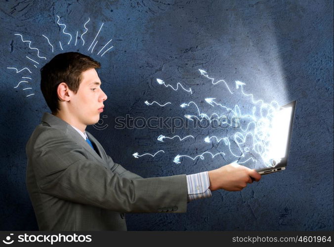 Man using laptop. Young man thoughtfully looking in laptop screen