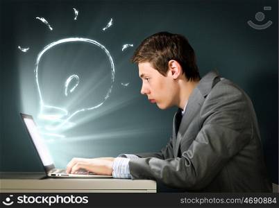 Man using laptop. Young man thoughtfully looking in laptop screen