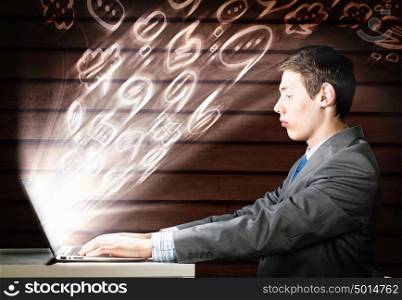 Man using laptop. Young man thoughtfully looking in laptop screen