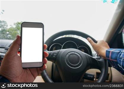 Man Using Mobile Phone Device While Driving. Cropped shot view Man looking smart phone in a car.