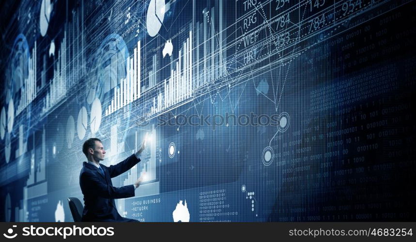 Man using modern technologies. Businessman in chair working with virtual panel