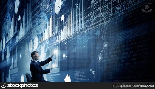 Man using modern technologies. Businessman in chair working with virtual panel