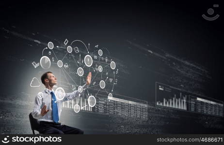 Man using modern technologies. Businessman in chair working with virtual panel