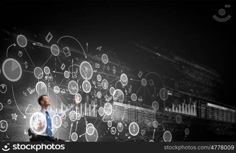 Man using modern technologies. Businessman in chair working with virtual panel