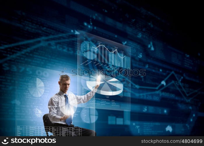 Man using modern technologies. Businessman in chair working with virtual panel