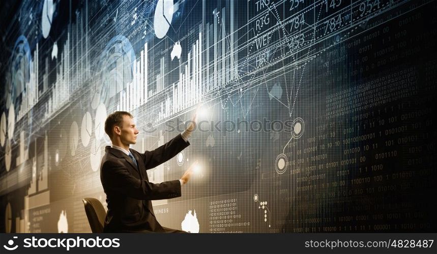 Man using modern technologies. Businessman in chair working with virtual panel