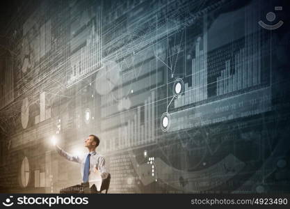 Man using modern technologies. Businessman in chair working with virtual panel