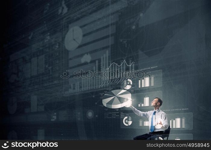 Man using modern technologies. Businessman in chair working with virtual panel