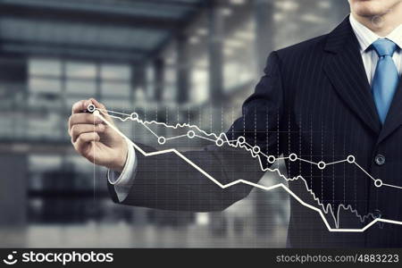 Man using modern technologies for business. Chest view of businessman drawing infographs on screen