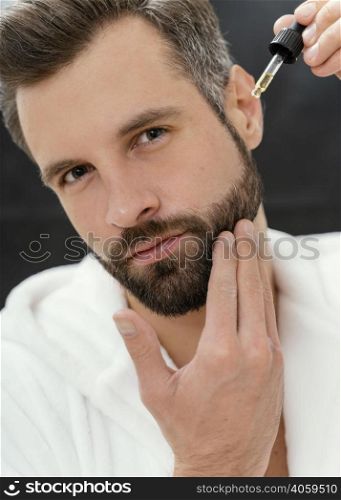 man using natural oils his face 4