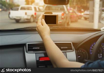 Man using navigator while driving a car in urban traffic road