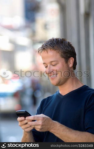 Man using PDA cellular on the street.