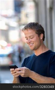 Man using PDA cellular on the street.