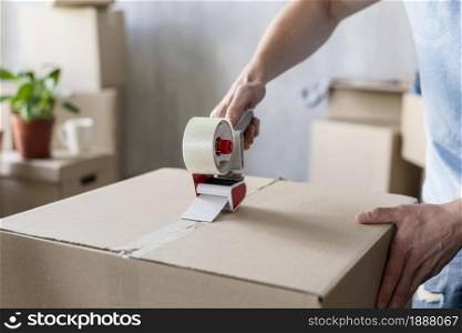 man using scotch tape box ready moving out . Resolution and high quality beautiful photo. man using scotch tape box ready moving out . High quality and resolution beautiful photo concept