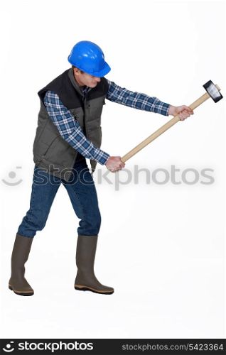 Man using sledge-hammer