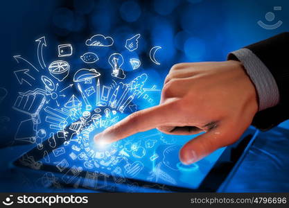 Man using tablet. Close up of human hand touching screen of tablet