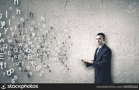 Man using tablet pc. Young businessman holding tablet pc and letter flying in air