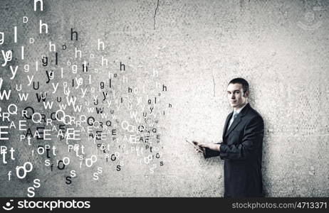 Man using tablet pc. Young businessman holding tablet pc and letter flying in air