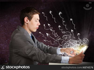 Man using tablet pc. Young emotional businessman looking in tablet pc