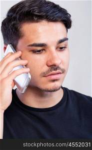 man using the phone. a young man with black using the phone, hand grabing a phone