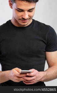 man using the phone. a young man with black using the phone, hand grabing a phone