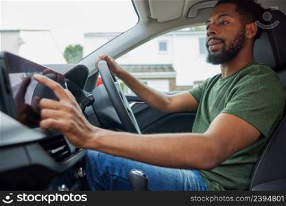 Man Using Touchscreen Whilst Driving Car