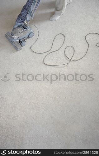Man Vacuuming the Carpet