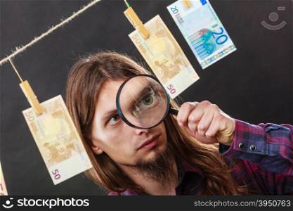 Man verify money cash. Currency exchange concept. Man worker check verify money cash. Payment hang on laundry line. Guy with loupe.