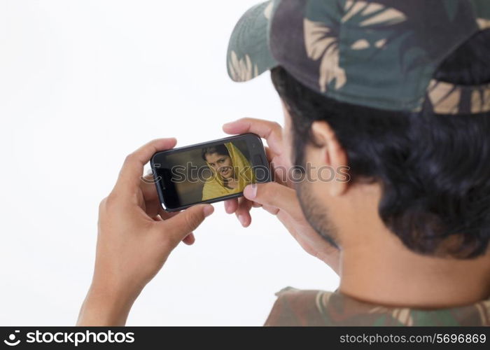 Man video chatting through mobile phone with a woman