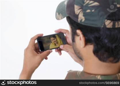 Man video chatting through mobile phone with a woman