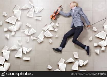 Man violinist. Young businessman running with violin in hand