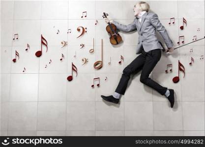 Man violinist. Young businessman running with violin in hand