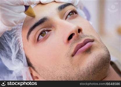 Man visiting dermatologyst for laser scar removal  