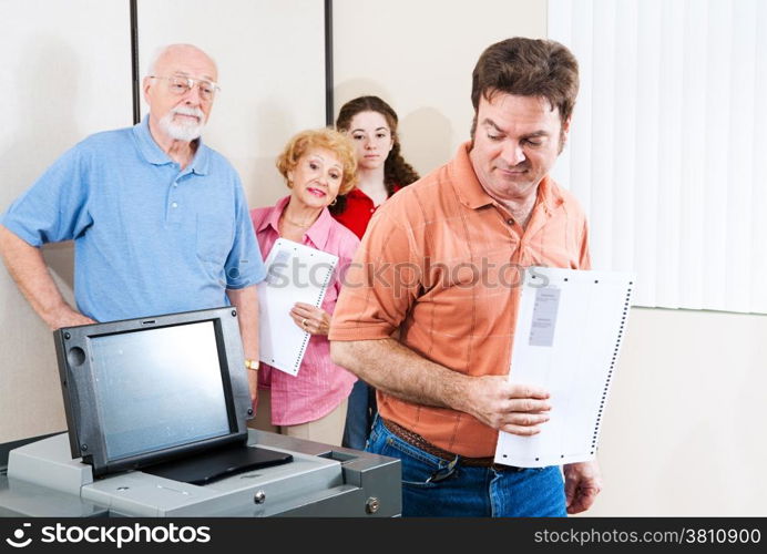 Man voting on a new touch screen machine for the first time.