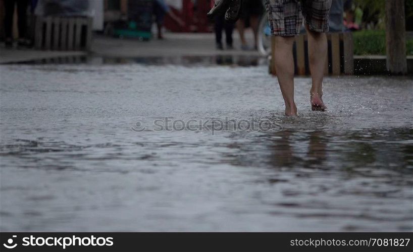 Man wading through flood waters