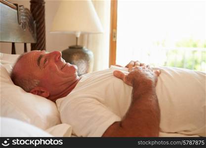 Man Waking Up In Bed In Morning