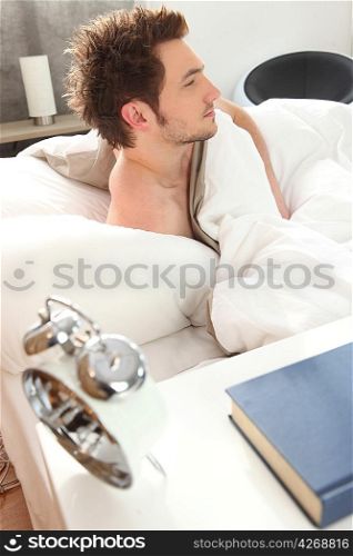 man waking up in his bed