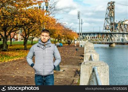 Man walking along the riverwalk in Portland city at autumn, Oregon, USA.