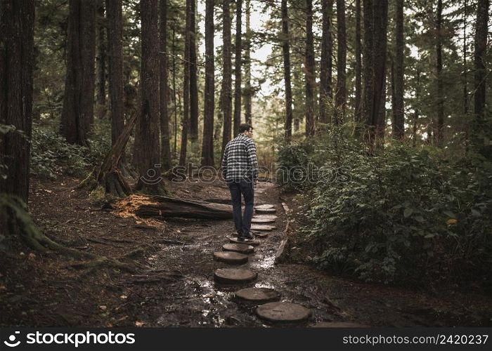 man walking forest