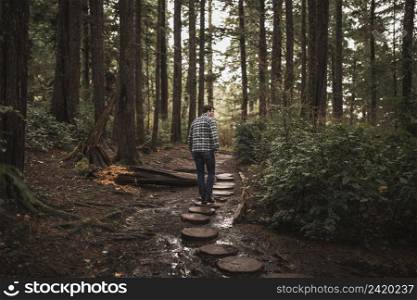 man walking forest