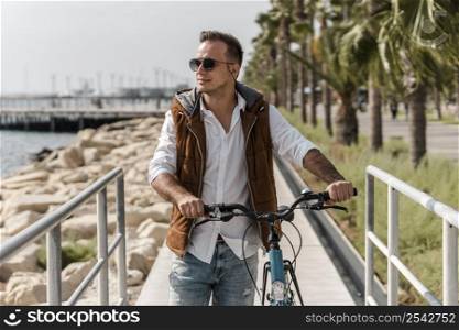 man walking his bike outdoors