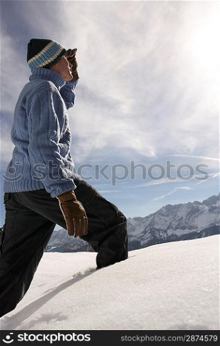 Man walking in fresh snow side view