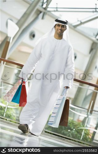 Man walking in mall smiling (selective focus)