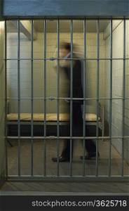 Man walking in prison cell